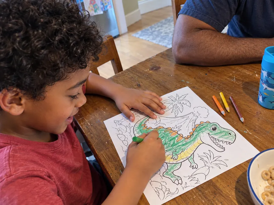Illustrative AI-generated scene of a child colouring a dinosaur page